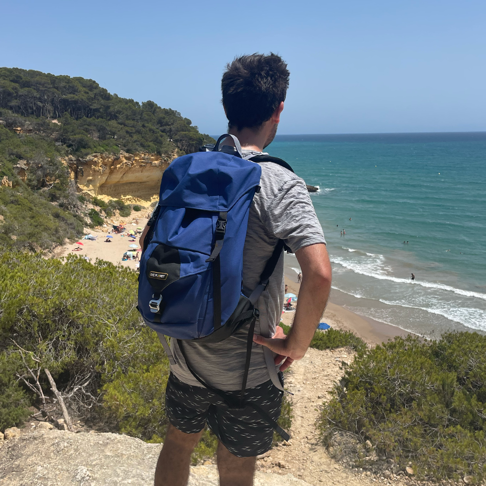 Day hiking the Cami de Ronda in Spain wearing a blue One Planet Zipless Australian made day pack